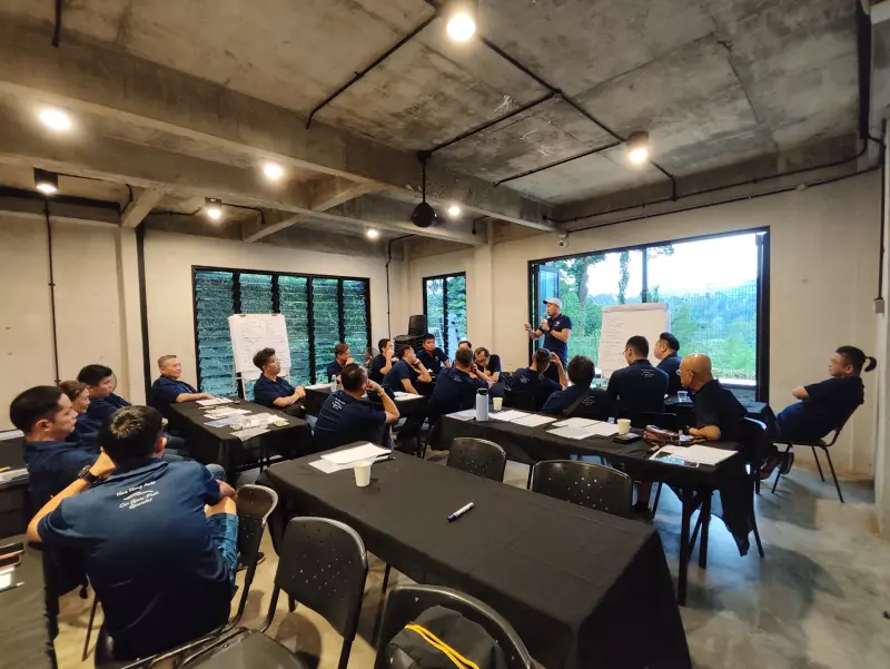 Corporate participants taking part in an indoor facilitated team-building workshop