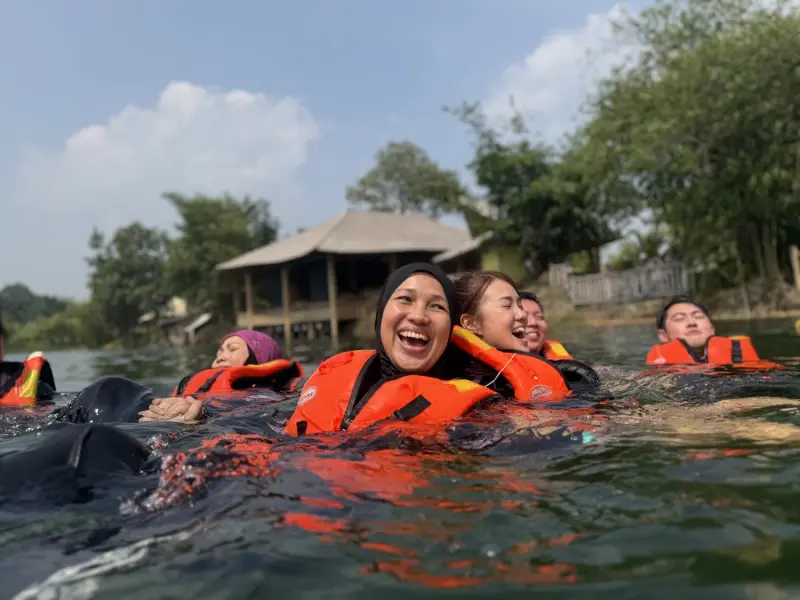 Participants laughing together during a facilitated lake mission